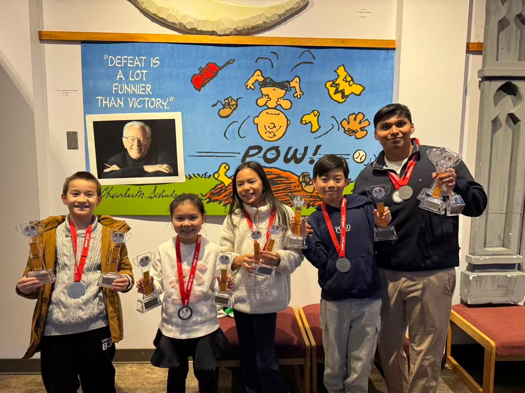 FLL Team 67843 mentors holding trophies